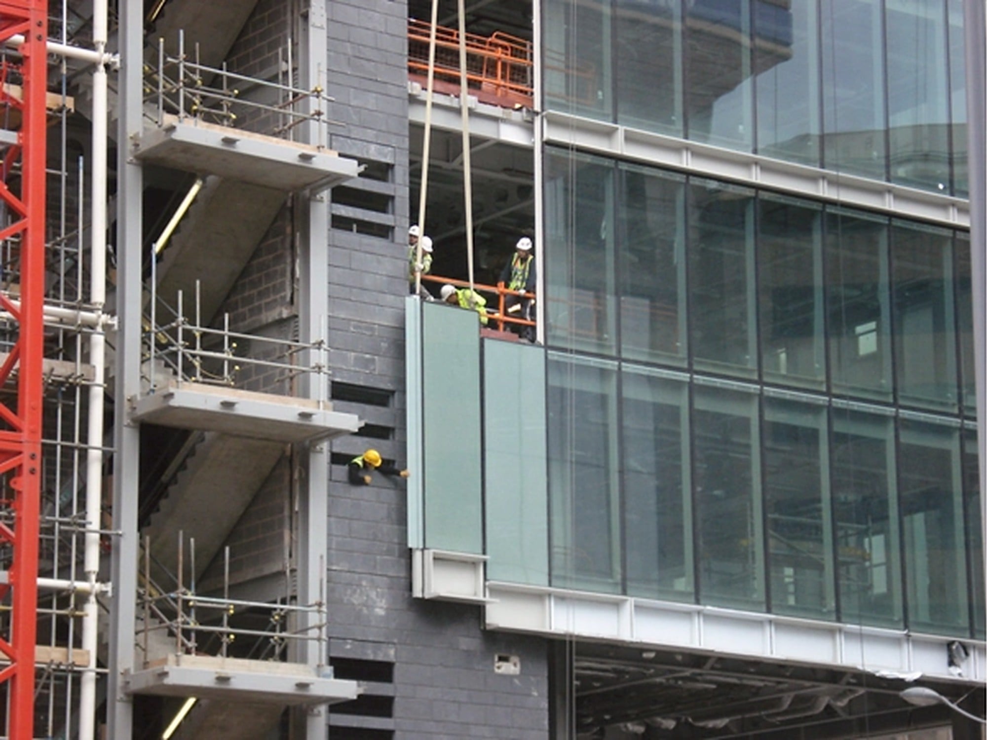 Installation of glass façade panels on a commercial building